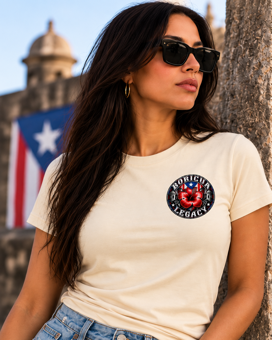 Woman wearing the Boricua Legacy crest slim-fit tee in apricot with the Puerto Rican flag behind her